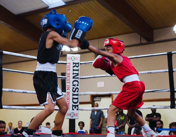 Boxer jabbing in a boxing ring with full gear