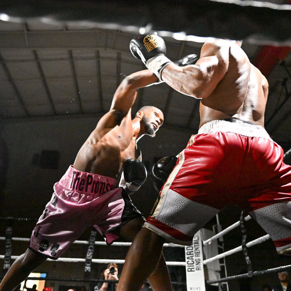 Boxer Adonis Wilkins throws a right handed punch at Elias Ajuwa in the corner of the ring.